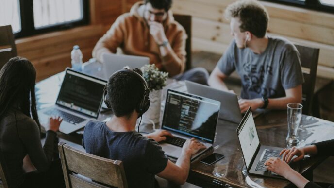 group of people using laptop computer