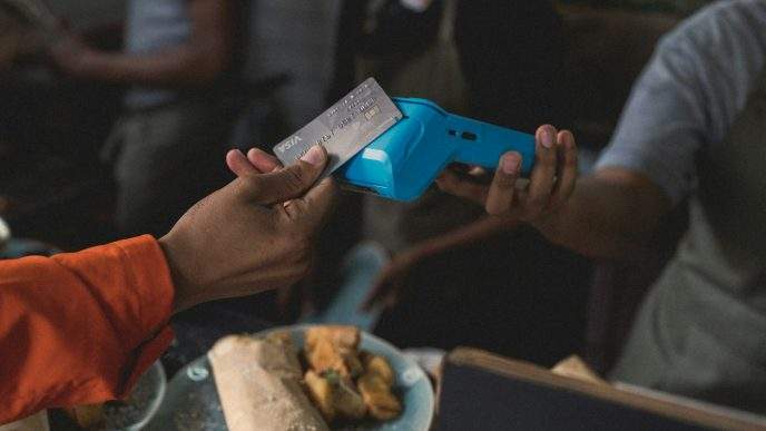 a person holding a blue object in their hand