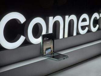 A cell phone is plugged into a connection sign