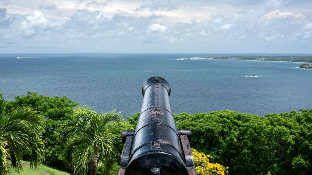 Trinidad and Tobago To Reverse Bitcoin Ban 1 A scenic view of a historic cannon overlooking the Atlantic Ocean from a fort in Tobago.