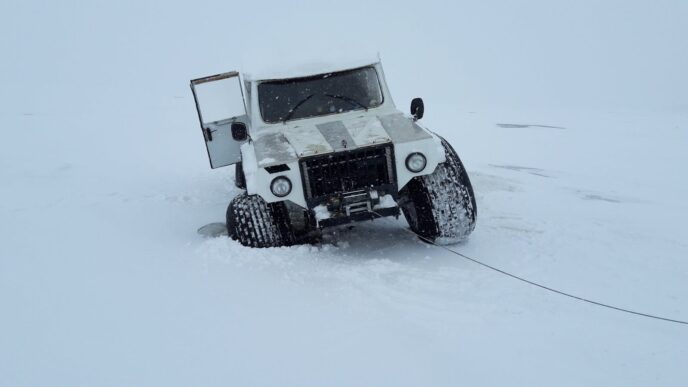 Stop Billing, Start Streaming: Austin Mitchell’s Case Against Net-30 Invoices 4 White 4x4 truck traversing snowy landscape in Karelia, Russia, showcasing adventure travel.
