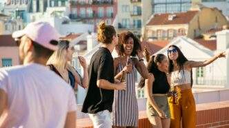 A lively group of friends enjoying a rooftop party in Portugal under a bright summer sun.