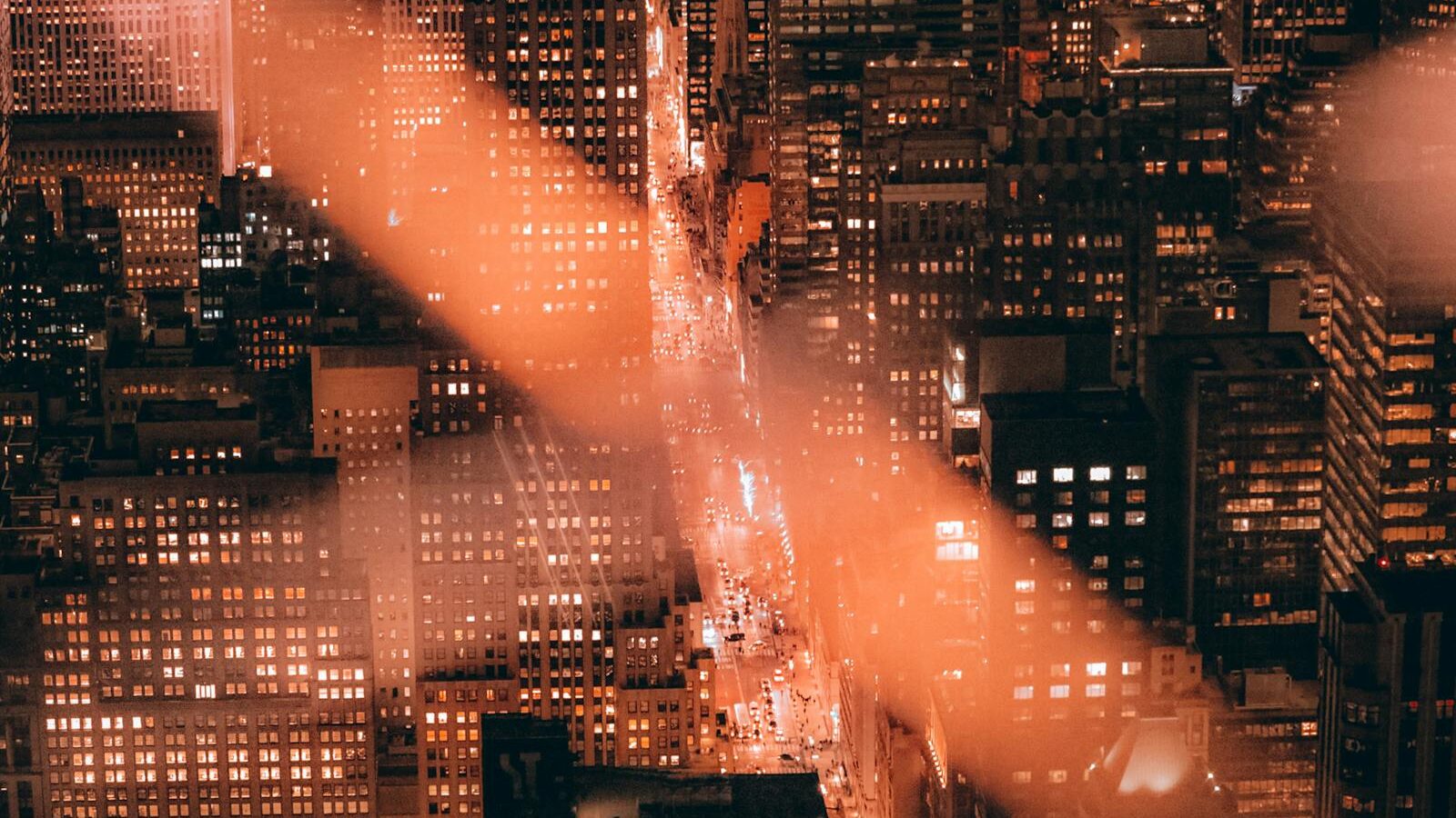 A breathtaking aerial shot of New York City's skyscrapers illuminated at night.