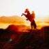 A cowboy on a rearing horse against a stunning sunset in rural Kayseri, Türkiye.