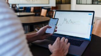 How Satora Connects Bitcoin to Stablecoins Without Custodians 6 person using smartphone and MacBook Pro