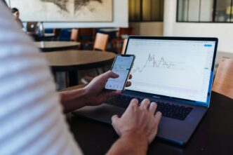 How Satora Connects Bitcoin to Stablecoins Without Custodians 11 person using smartphone and MacBook Pro