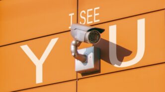 a security camera mounted to the side of a building