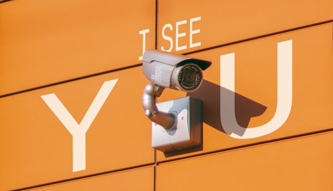 a security camera mounted to the side of a building