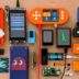 A tabletop covered with more than a dozen DIY bitcoin signing devices in various enclosures, alongside loose components and smartcards.