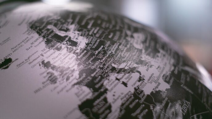 grayscale photo of desk globe
