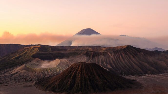 silhouette photo volcanoes during golden hour